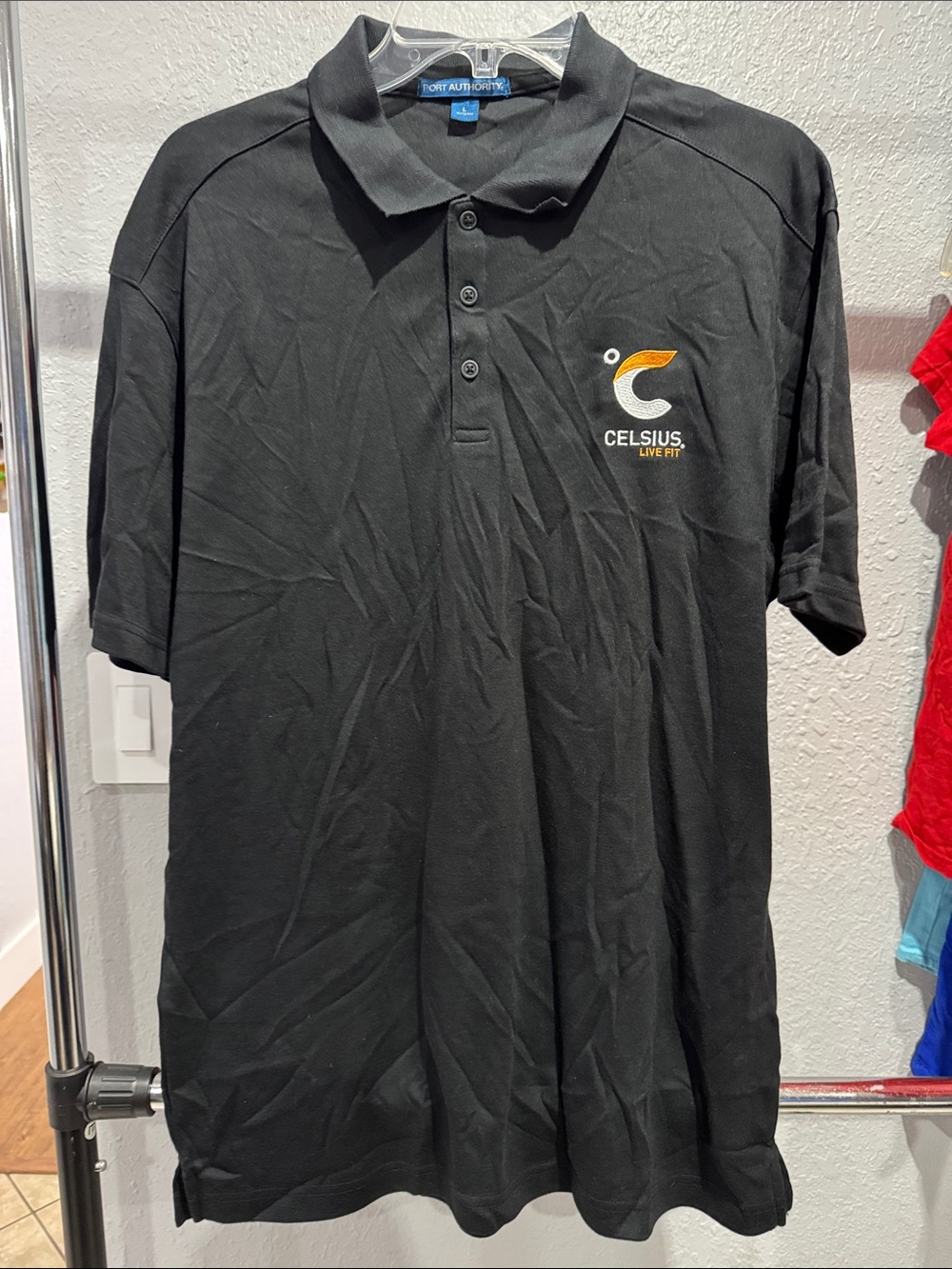 Port Authority Black Polo with Orange and White Logo